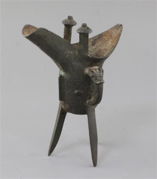 A Chinese archaic bronze wine vessel, Jue, Shang dynasty or later, height 19cm, repair to one leg